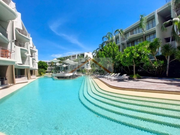 SC94164 Baan Sankram Condo lush green common areas with a state of the art infinite sea view pool/area.